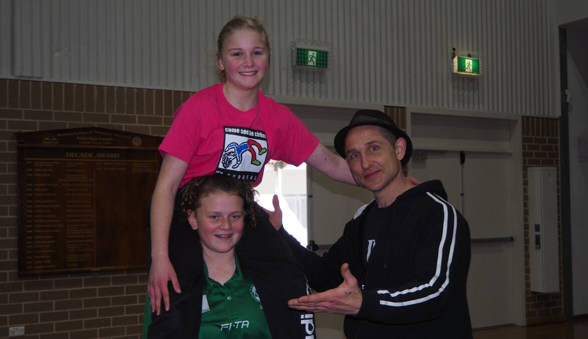 ACROBATS: New Kelso High Cirkus Surreal trainer Stuart Christie with Year 8 students Jessica Christian and Georgia Milligan. Photo: SAM BOLT