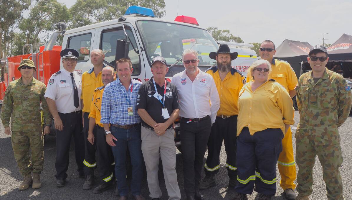 GRATITUDE: NSW Rural Fire Service assistant commissioner Peter McKechnie, Bathurst MP Paul Toole, mayor Bobby Bourke and Supercars chief operating officer Shane Howard with NSW RFS and ADF members. Photo: SAM BOLT