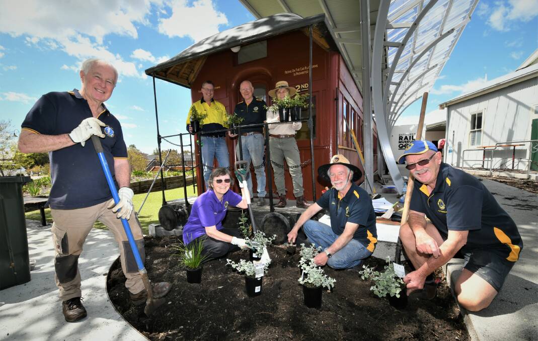 PLANT WORKS: Bathurst Rail Museum co-ordinator Ben O'Regan, project chair Dean Ward and ecological consultant Dhyan Blore with members of the Mount Panorama Lions Club. Photo: CHRIS SEABROOK 101921crlygardens