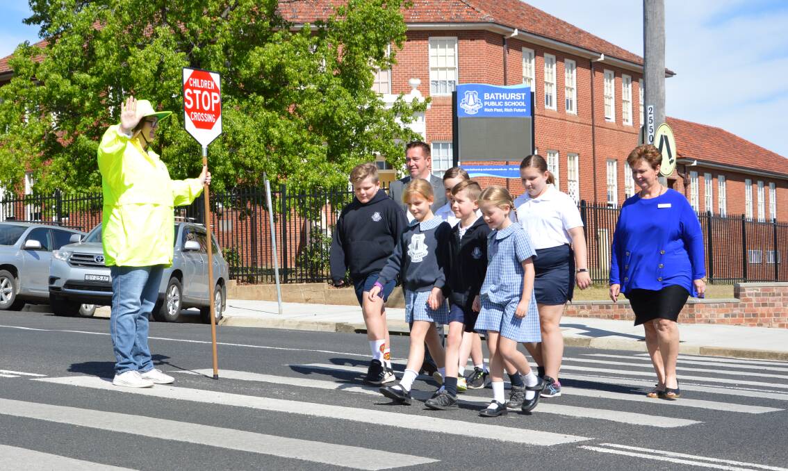 SAFE TO CROSS: Bathurst MP Paul Toole and Bathurst Public School principal Kate White join students on the pedestrian crossing with new supervisor Claire Nelson.