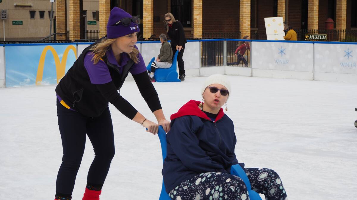 TEAMWORK: LiveBetter community access manager Michelle Stark helps Kristie navigate the ice rink during yesterday's All Abilities Day. Photo: SAM BOLT