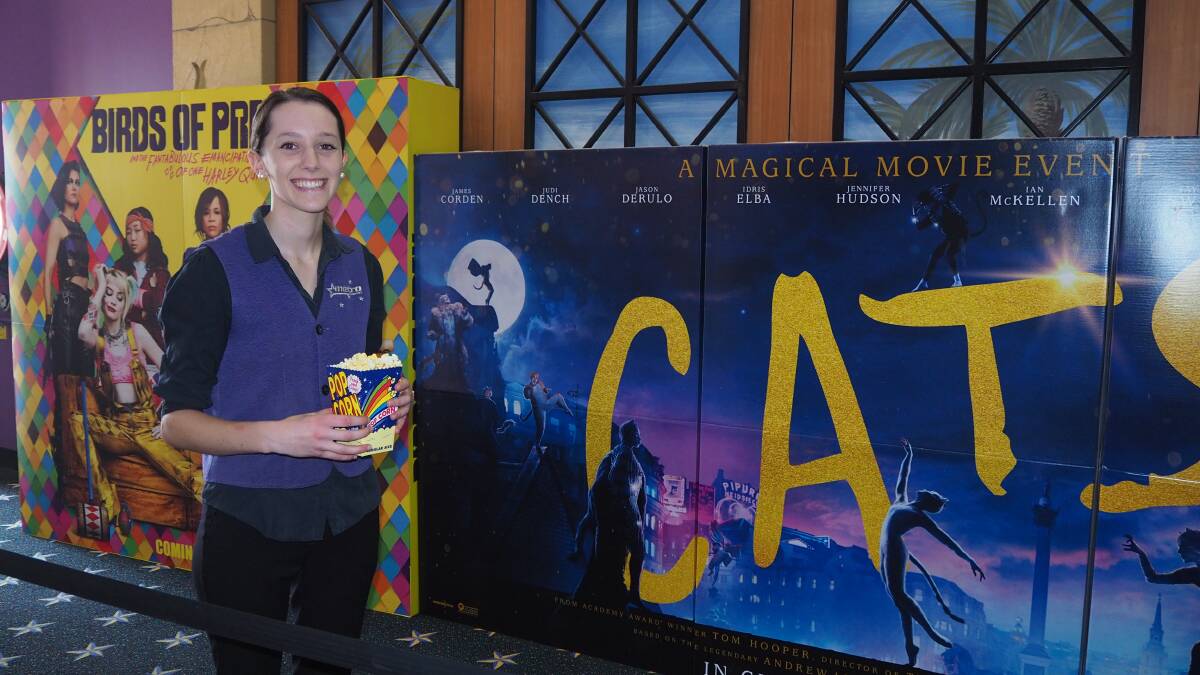 AT THE MOVIES: Metro Cinemas staff member Phoebe Morrison with displays promoting present and upcoming movies. Photo: SAM BOLT