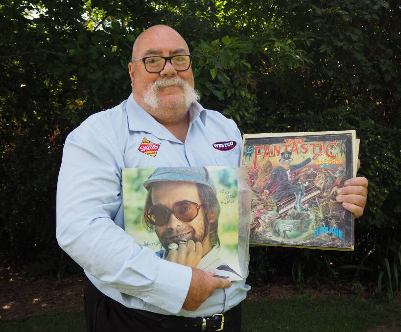 MEGA FAN: Bathurst sporting identity Tony Lewis with some notable selections from his immense Elton John collection. Across 40 years, Mr Lewis has seen the music legend live eight times.  Photo: SAM BOLT 020619sbtony1
