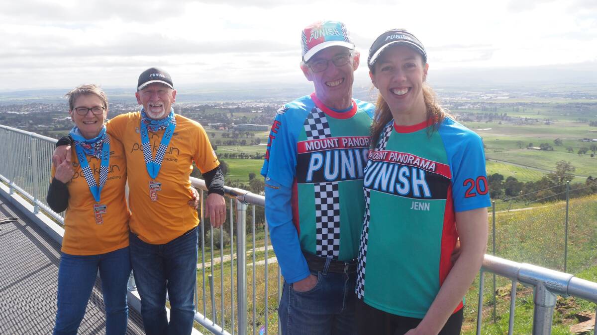 AT THE SUMMIT: Mount Panorama Punish race directors Stephen Jackson and Jennifer Arnold [foreground] with UK participants Pam and Jim Alcorn [background]. Photo: SAM BOLT