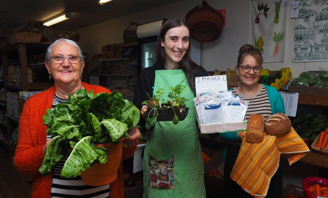 PRODUCE: Bathurst Wholefood Co-Op volunteers Kerry Forbes, Aspen Beilharz and Cheryl Grabham with a taste of what to expect at this Saturday's mini market. Photo: SAM BOLT