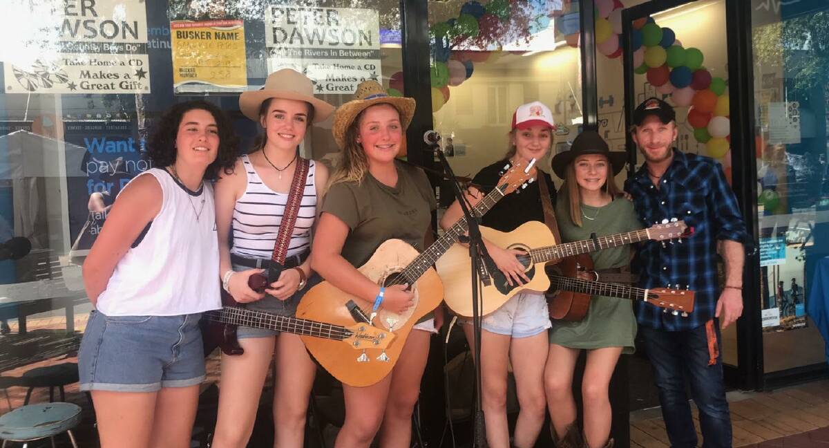 BUSKING: Bathurst Academy of Music manager Mickey Pye [far right] with Jenna Orpwood, Belle Whitwell, Jasmine Gold, Tameka Kennedy and Cleo Cheney. Photo: SUPPLIED