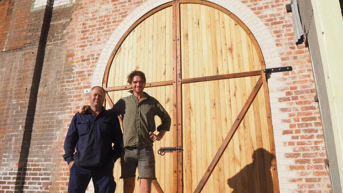 CRAFTSMANSHIP: Local builders Lawrence Sim and Blair Stapley with the arched door they've recently built at Tremain's Mill. Photo: SAM BOLT