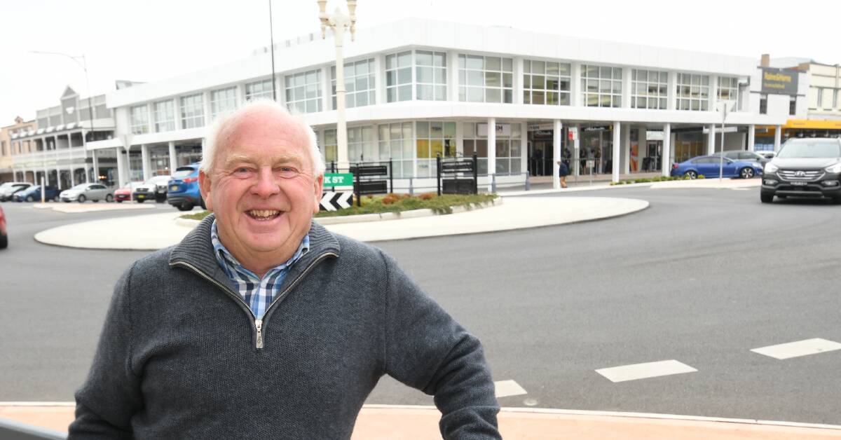 MAN OF MANY HATS: Dave Pennells with the former AMP building at back which he helped to reinvent with the late Bruce Bolam. Photo:CHRIS SEABROOK 