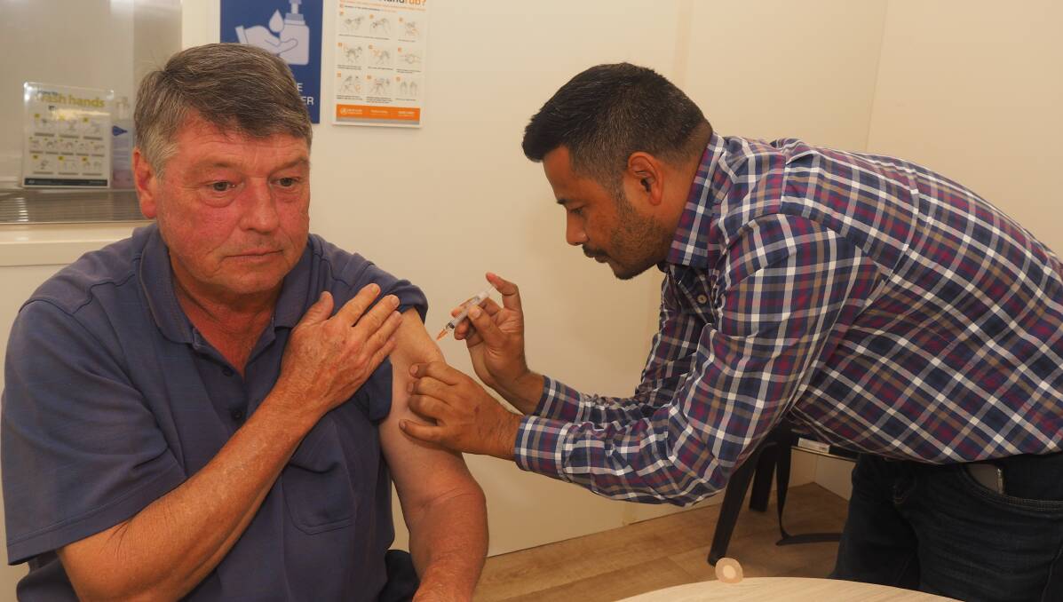 INITIAL JAB: Jim Schumacher receives his first AstraZeneca vaccine dose from Dr Sarju Shrestha at Ochre Health Medical Centre on Tuesday. Photo: SAM BOLT