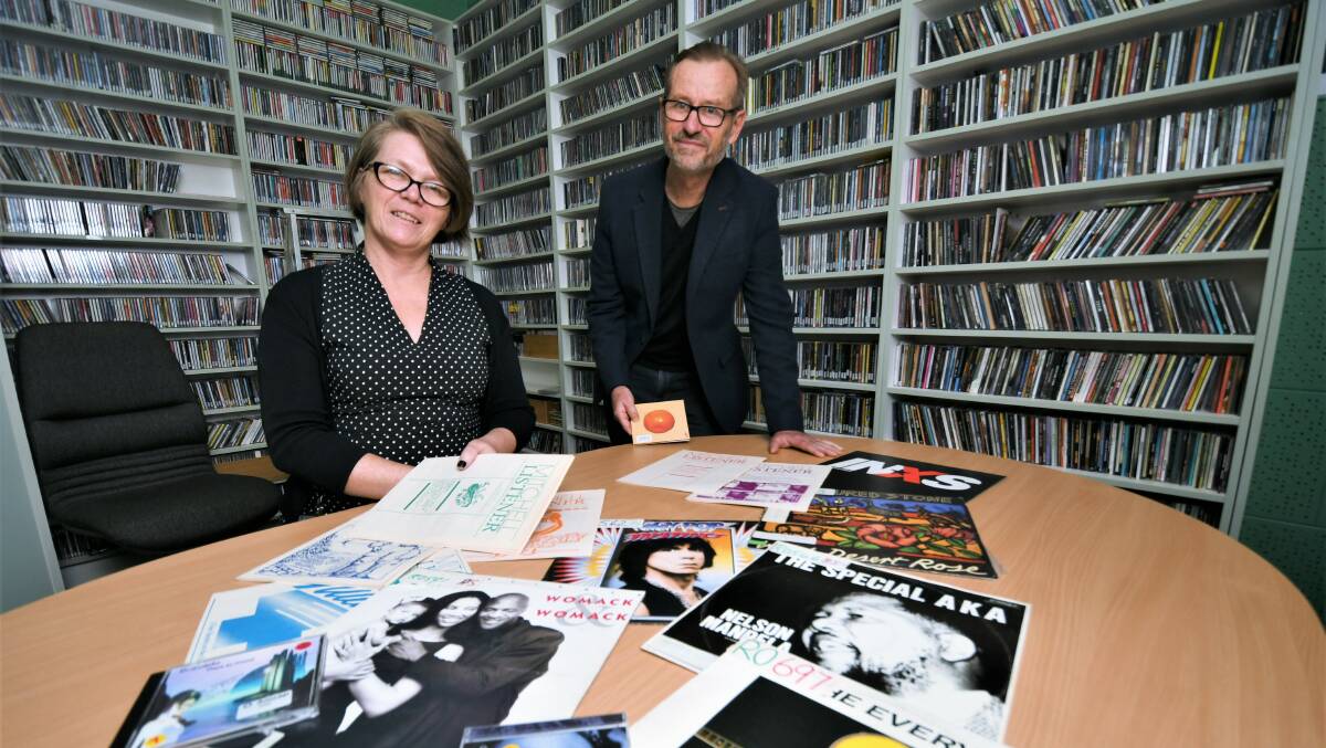THROUGH THE ARCHIVES: 2MCE station manager Lisa McLean and board member Brett Van Heekeren sifting through the station's vast music collection. Photo: CHRIS SEABROOK
