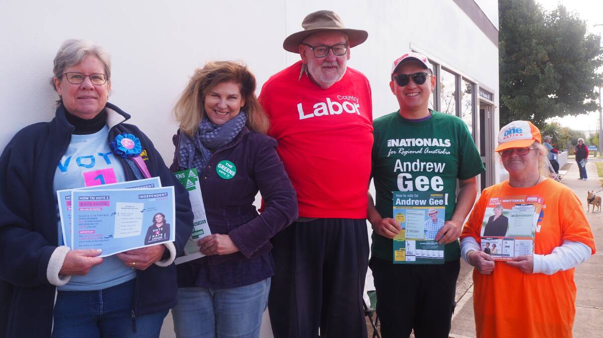 CAST YOUR VOTE: Volunteers from parties contesting Calare outside the Bathurst pre-polling centre at 91 Rankin Street on Monday. Photo: SAM BOLT