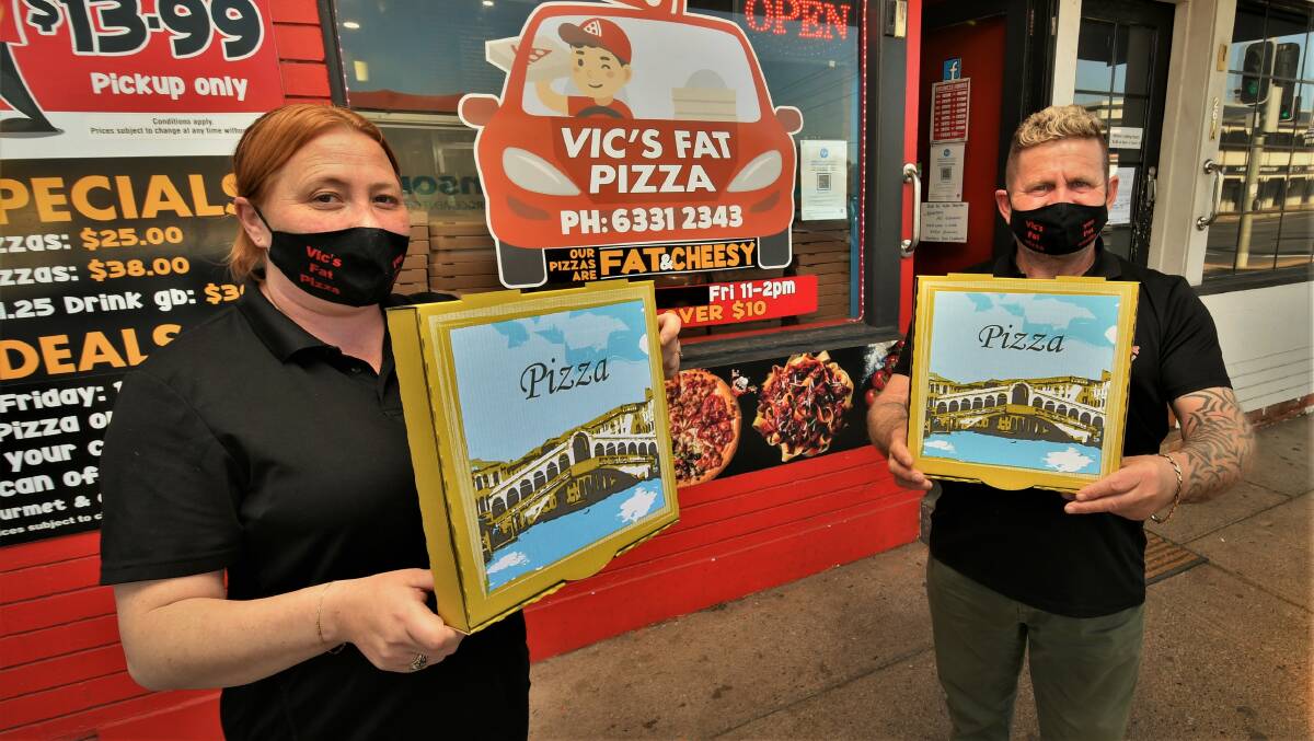 DOING THEIR BIT: Vic's Fat Pizza manager Rhonda Davis and owner Vic Issa at their 261B Stewart Street store. Photo: CHRIS SEABROOK