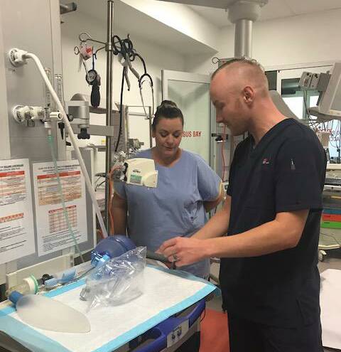 HARD AT WORK: Registered nurse Kane Horan [right] on the job at Bathurst Base Hospital. Photo: SUPPLIED