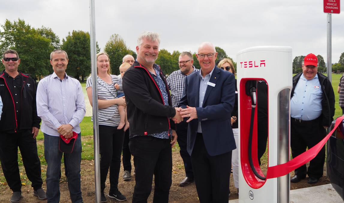 ELECTRIC AVENUE: Tesla Owners Club of Australia president Mark Tipping and mayor Graeme Hanger at the opening of Bathurst's first permanent Tesla Supercharger station. Photo: SAM BOLT 040919sbtesl1