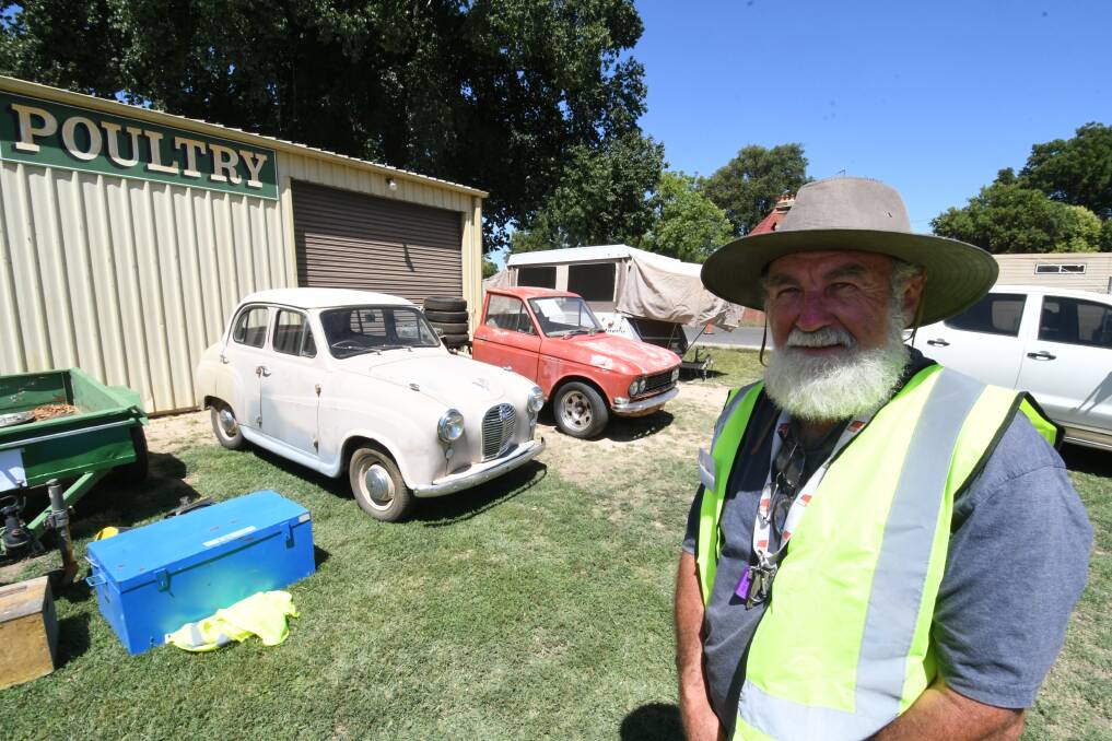 BARGAINS: Bathurst Swap Meet co-ordinator Steve Crain with his two vehicles fore sale in the background. Photo:CHRIS SEABROOK 020319cswap1a