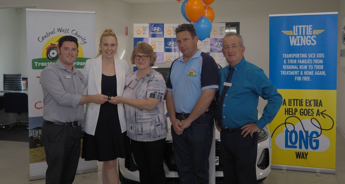PASSING OVER THE KEYS: [from left] Bathurst Motors' James Vanderhel, Little Wings chief executive officer Clare Pearson, raffle winner Catherine Williams, Central West Tractor Trek Group president Nick Clancey and mayor Bobby Bourke. Photo: SAM BOLT