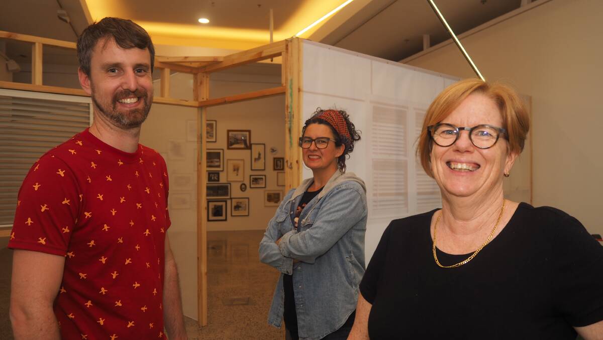 QUITE AT HOME: Todd Fuller, Kellie O'Dempsey and Catherine O'Donnell with a part of their collarborative effort, 'Hardenvale: Our Home in Absurdia'. Photo: SAM BOLT
