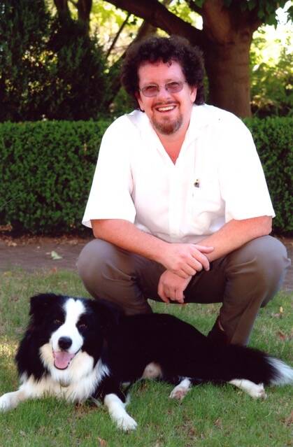 REMEMBERING A LOYAL FRIEND: Father Paul Devitt with his late pet dog, 'Nic.' Photo: SUPPLIED