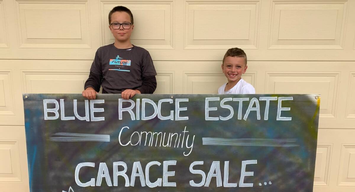 GRAB A BARGAIN: Sam and Jack Moras promoting this weekend's community garage sale at the Blue Ridge estate.