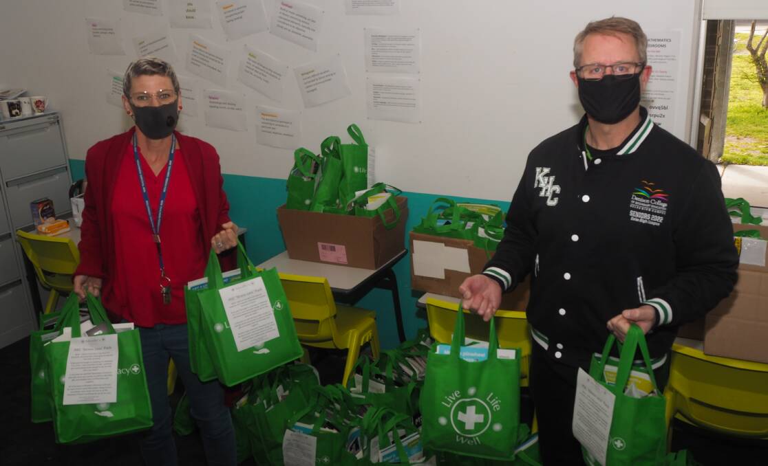 CARE PACKAGES FOR STUDENTS: Kelso High Campus senior mentor Jude Murphy and principal Michael Sloan. Photo: SAM BOLT