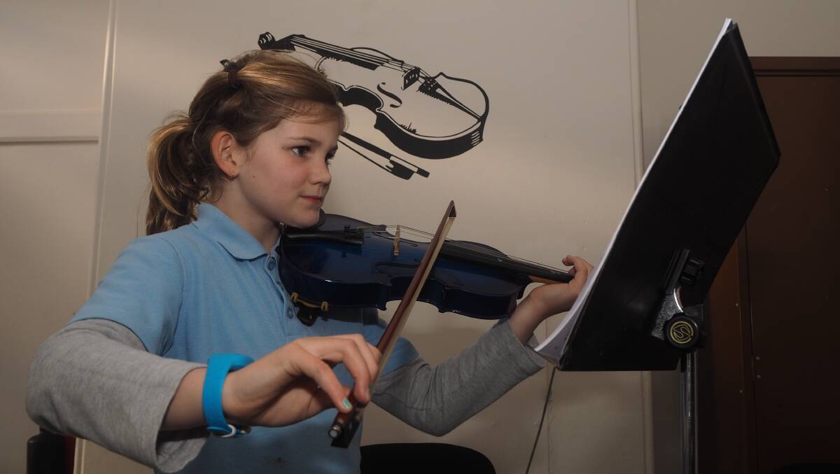 PRACTICE MAKES PERFECT: Mitchell Conservatorium violin student Ruby Longmore participates in a lesson at the institution's new 130 Havannah Street site on Thursday. Photo: SAM BOLT