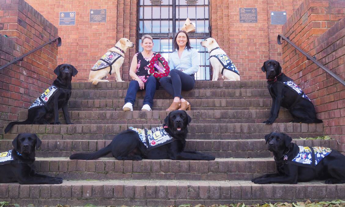 SERVICE DOGS: Bathurst RSL Sub Branch members Jennifer Brooker and Carla Gallwey with Labradors-in-training. Photo: SAM BOLT