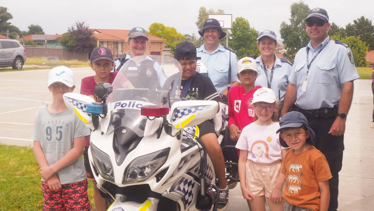 ON THE BIKE: Chifley Police District officers with children from the Kelso community at a school holiday event on Tuesday. Photo: SAM BOLT