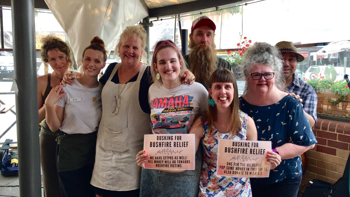 LIVE AID: Pandora Holliday, Erin McMahon, Maggie de Vries [Piccolo's on William owner], Gabbi Bolt, Andy Nelson, Abby Smith, Genni Kane and Jon Wilby after yesterday's busking session. Photo: SAM BOLT