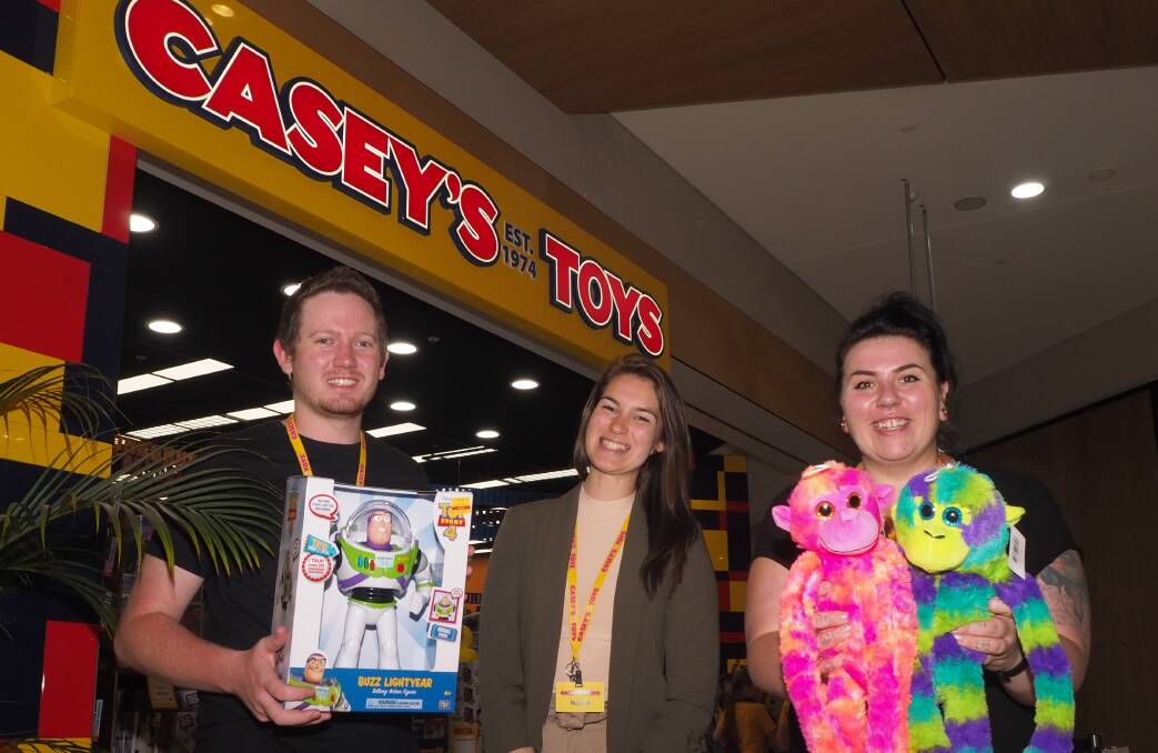 TOY STORY: Toycorp retail area manager Naomi Ramirez [centre] with Casey's Toys Bathurst staff member Josh Williamson and store manager Amy De Ville. Photo: SAM BOLT