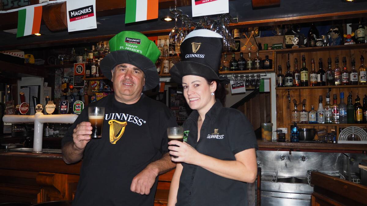 CHEERS: Jack Duggans Irish Pub staff members Glyn and Jess Daunt a promising a bumper day of celebration for St Patrick's Day. Photo: SAM BOLT