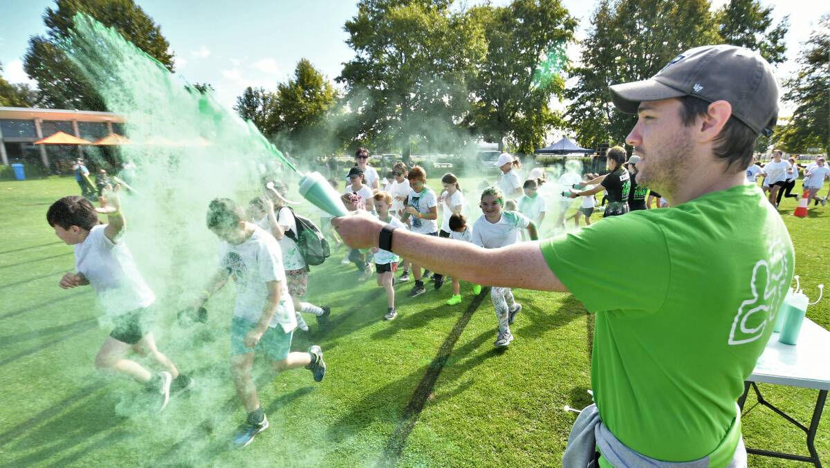 EASY BEING GREEN: The start of Sunday's 'Chase the Rainbow' colour run at Morse Park. Photo: CHRIS SEABROOK