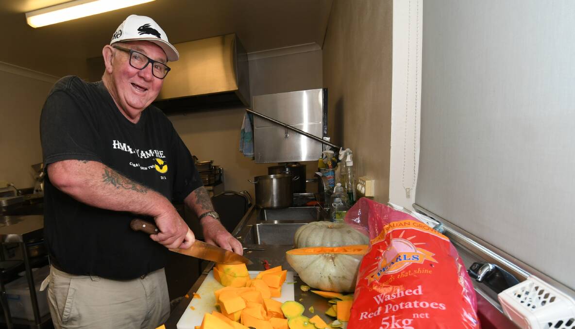 IN THE KITCHEN: Bathurst community Christmas lunch organiser Barney Rumble preparing pumpkin for the lunch. Photo: CHRIS SEABROOK