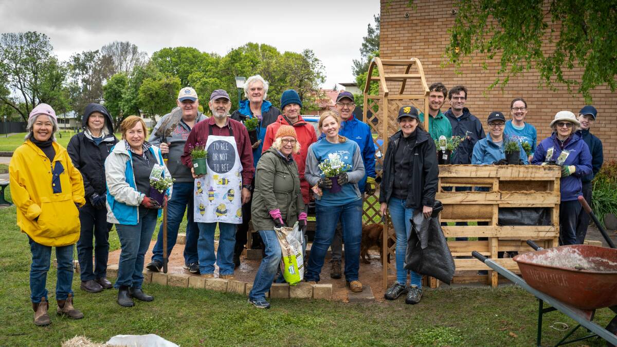 TEAM EFFORT: Volunteers constructing the pollinator garden at Charles Sturt University's Bathurst campus. Photo: SUPPLIED
