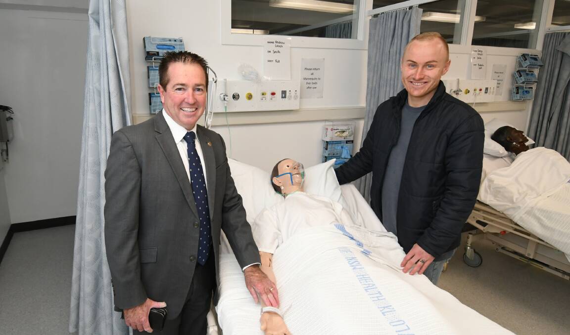 PATIENCE WITH PATIENTS: Member for Bathurst Paul Toole with registered nurse Kane Horan at Bathurst TAFE's health care faculty. Photo:CHRIS SEABROOK 071320ctafe1