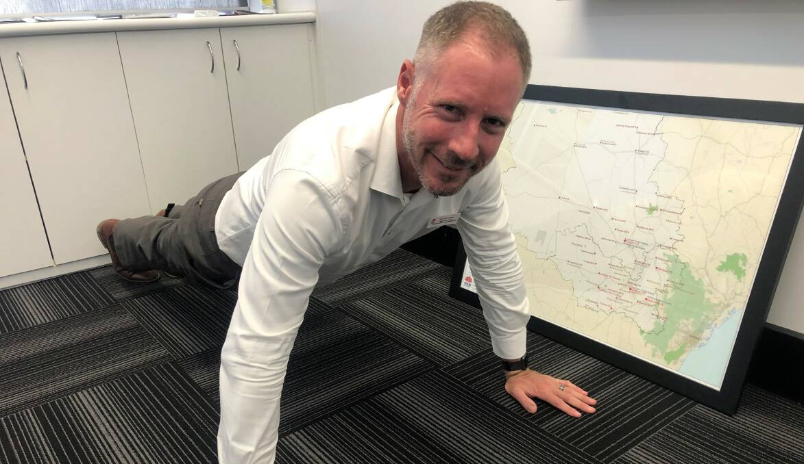 EXERCISE: Western NSW Local Health District chief executive officer Scott McLachlan attempting a push-up for the team. Photo: SUPPLIED