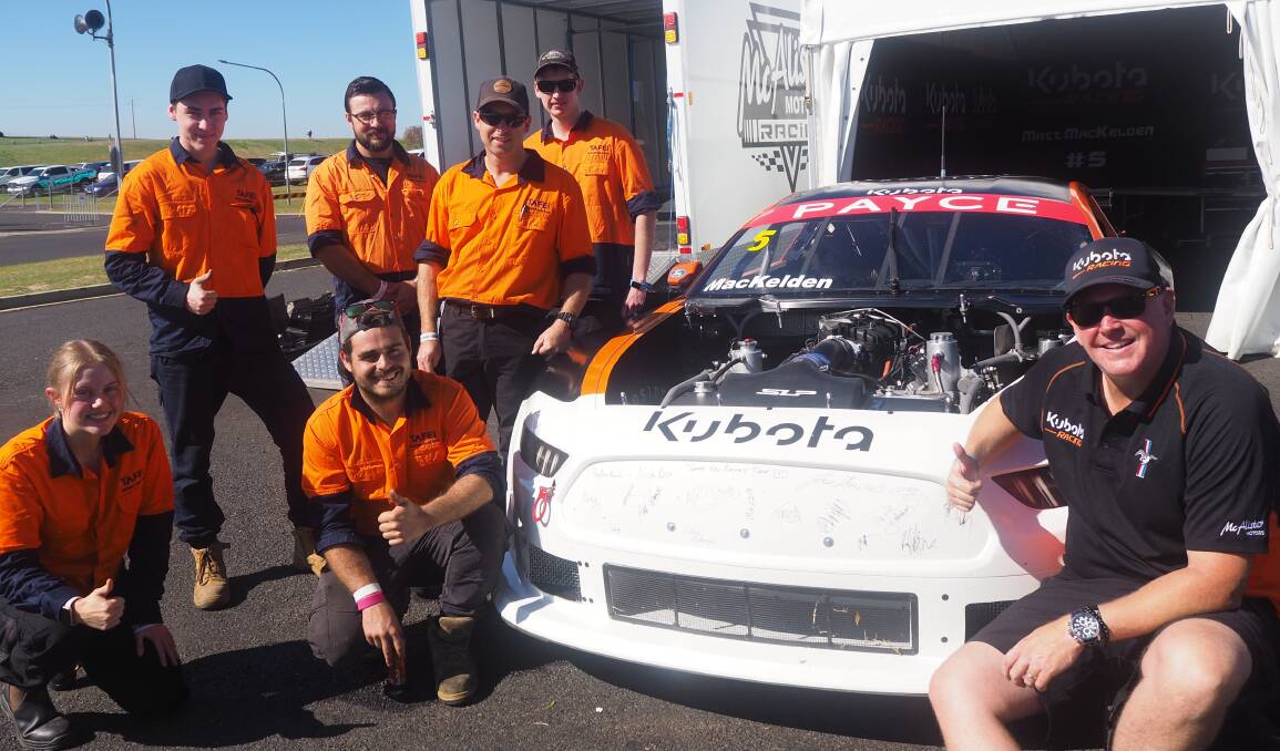 SIGNING OFF ON A GOOD JOB: TAFE NSW Motorsport Repair Team members with Kubota Racing's Matthew MacKelden. Photo: SAM BOLT