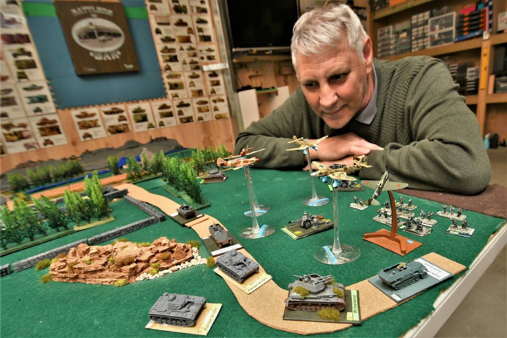 WAR GAMES: David Stanley with his World War II tabletop battle scenario. Photo: CHRIS SEABROOK 111521cwargames