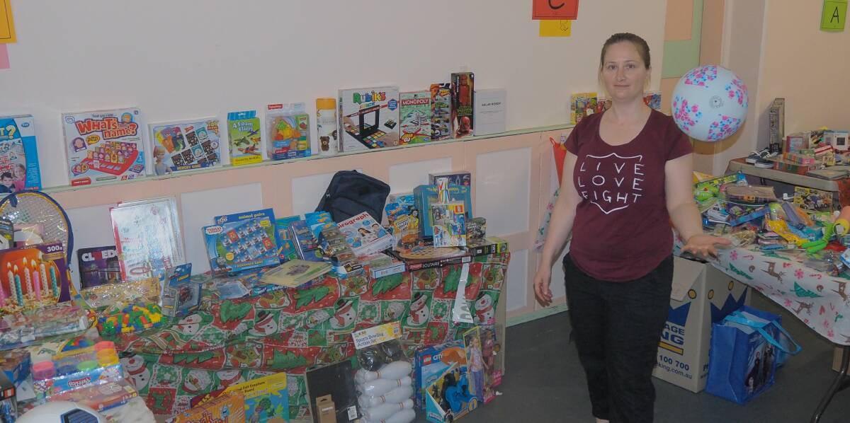 GENEROSITY: Lieutenant Kate Cathcart of Bathurst's Salvation Army branch with some of the gifts set to bring Christmas cheer for less fortunate children. Photo:SAM BOLT