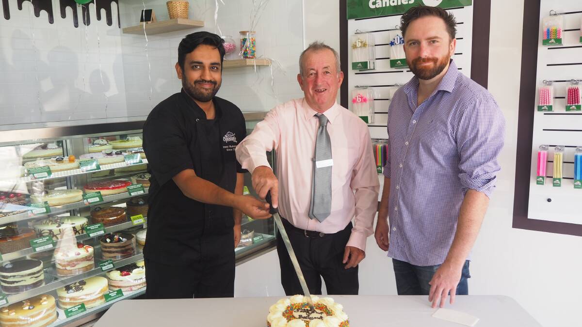 CUT THE CAKE: The Cheesecake Shop Bathurst franchisee Imran Muhammad, mayor Bobby Bourke and councillor Alex Christian. Photo: SAM BOLT