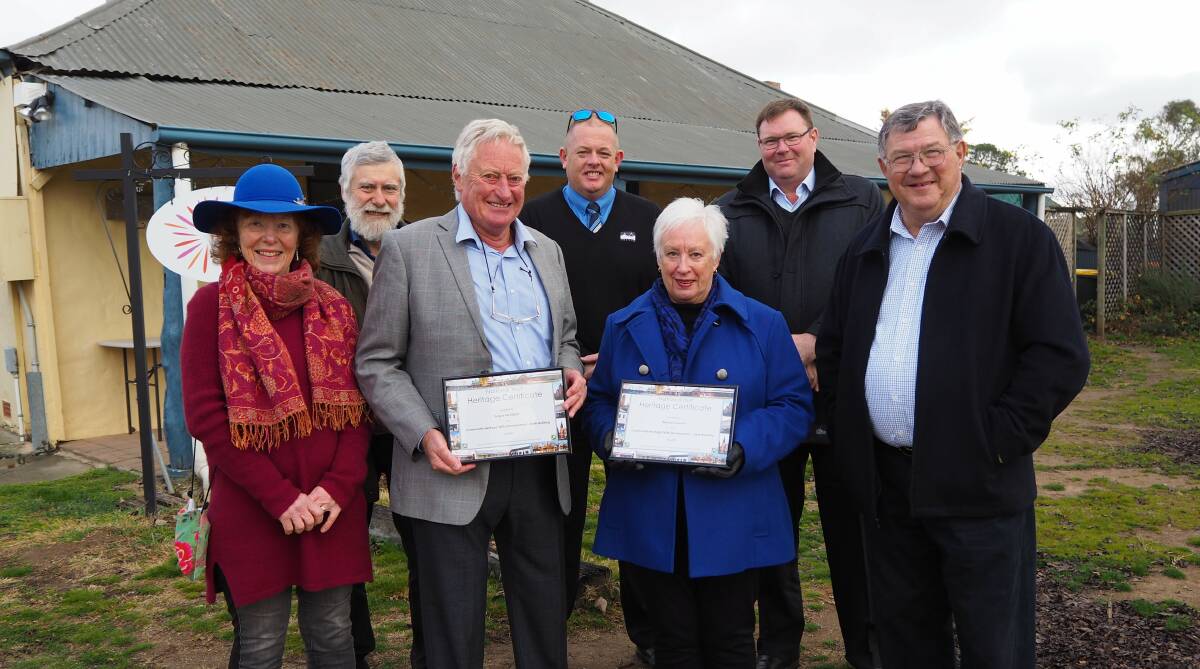 RESTORATION: O'Connell earth building workshop coordinator Angus McKibbin and Oberon mayor Kathy Sajowitz receive their National Trust Heritage Awards from Bathurst branch chairman Iain McPherson. Photo: SAM BOLT