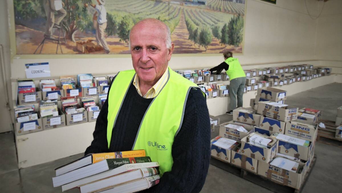 BOOKED IN: Lifeline Central West executive director Alex Ferguson preparing for the Bathurst Book Fair at the Showground. Photo: CHRIS SEABROOK