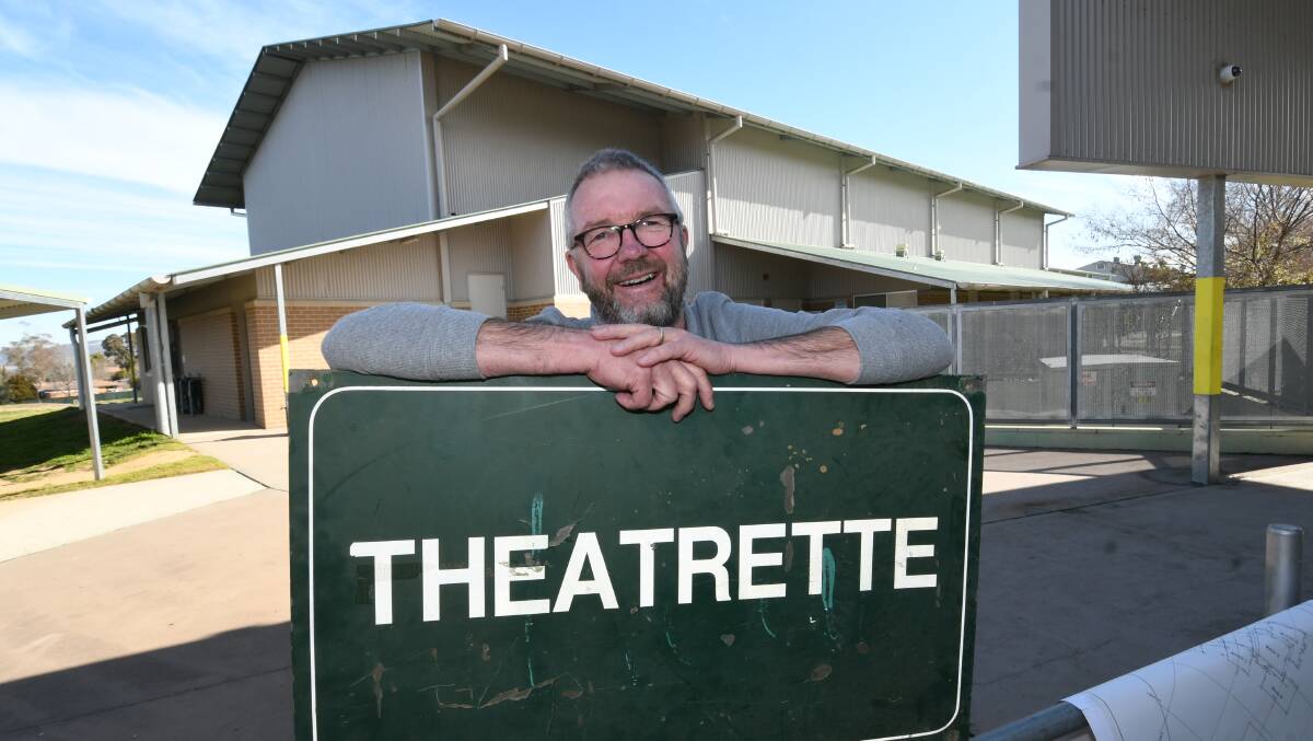 MEMORIES: Former Kelso High teacher Hans Stroeve with the original school's theatrette sign spared by the 2005 fire. Photo: CHRIS SEABROOK