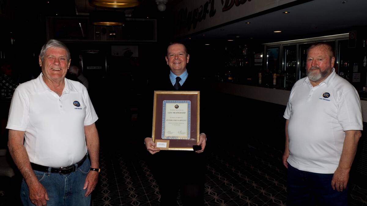 HUMBLING HONOUR: Bathurst RSL Club general manager Peter Sargent [centre] receiving his life membership last week from president Ian Miller and vice-president Ron Hollebone. Photo: SAM BOLT