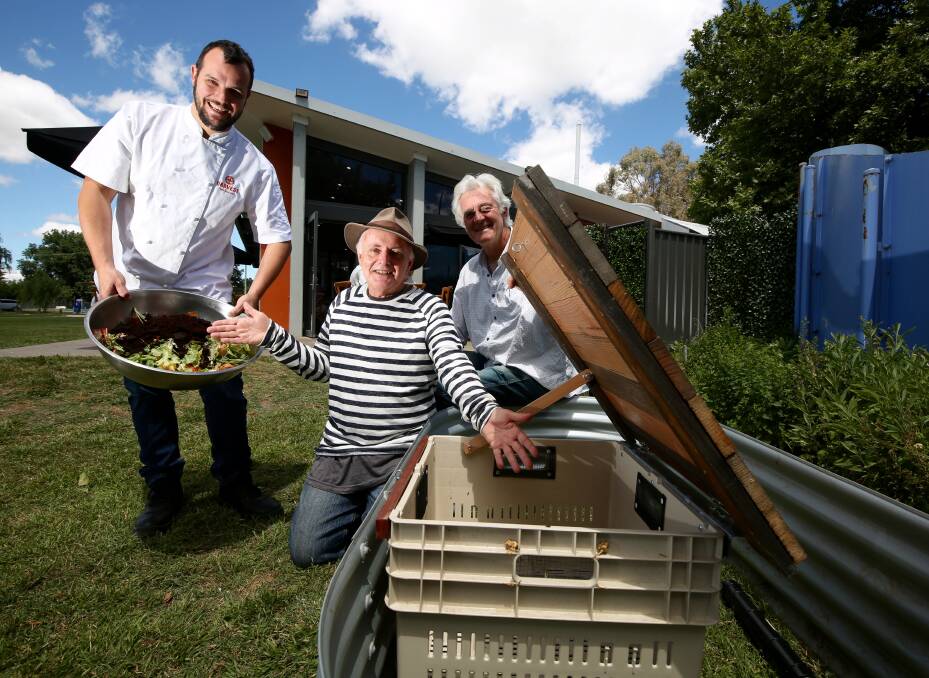 IDEAS FOR WASTE: Councillor John Fry [right] with Harvest Cafe owner Chris Ringrose and Sydney sustainability coach Michael Mobbs with a prototype wicking bed. Photo: PHIL BLATCH