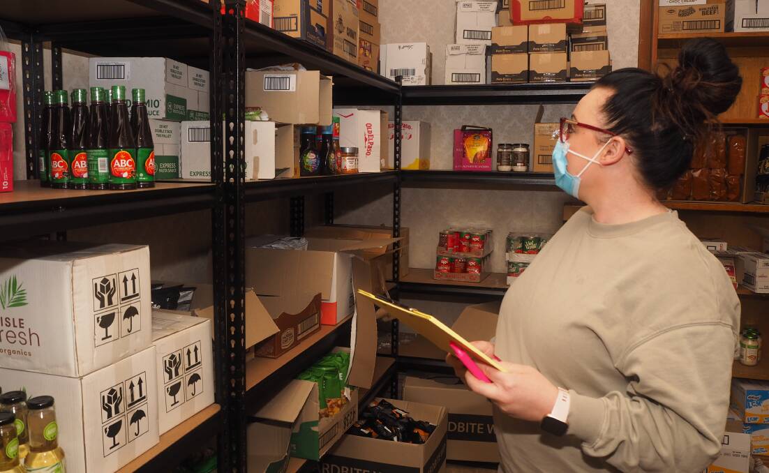 KEEPING STOCK: The Greens on William manager Rebecca Mathie inside the club's stockroom. Photo: SAM BOLT