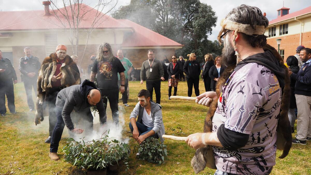WARDING OFF BAD SPIRITS: Wiradyuri elders stage a smoking ceremony to christen the new elders space at Charles Sturt University. Photo: SAM BOLT
