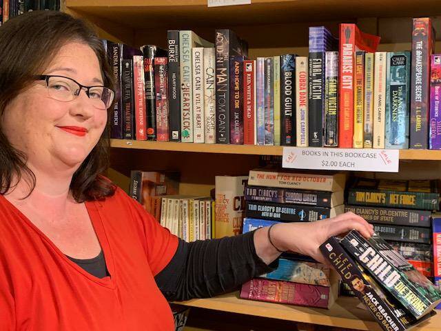 PRE-LOVED TITLES: Sofala Book Shop owner Anna Clark with some of the titles available for online purchase. Photo: SUPPLIED