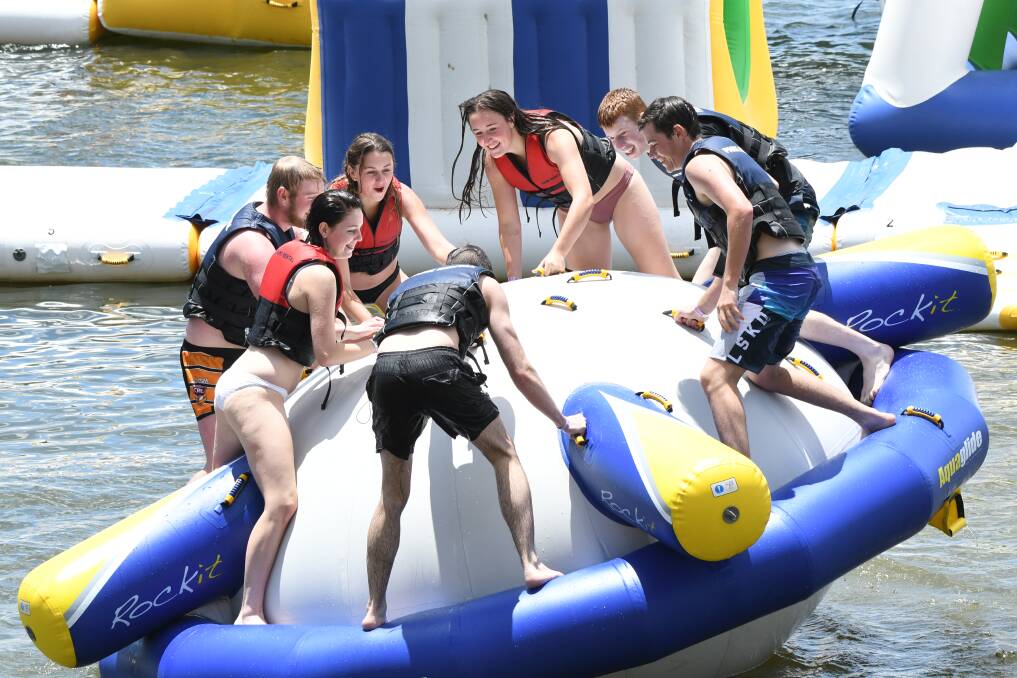 THRILLS AND SPILLS: Teenagers enjoying the attractions out at the Bathurst Aqua Park on Sunday. Photo:CHRIS SEABROOK  122318caqua1