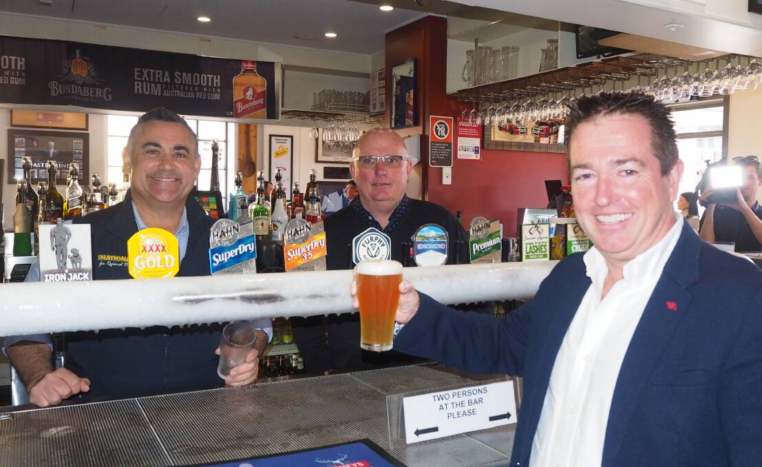 FIRST DRINKS: Deputy Premier John Barilaro and Knickerbocker Hotel owner Scott Macallister serve a beer to Bathurst MP Paul Toole. Photo: SAM BOLT