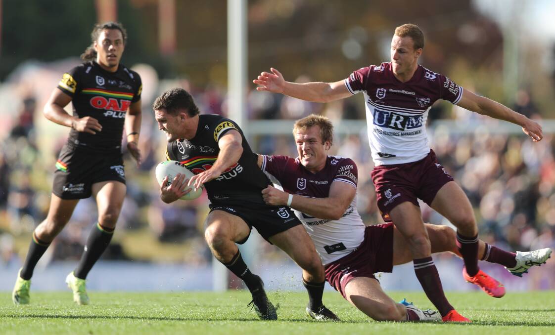 TACKLE: Penrith's Nathan Cleary tries to avoid Manly's Jake Trbojevic and Daly Cherry-Evans at Carrington Park on Saturday. Photo: PHIL BLATCH